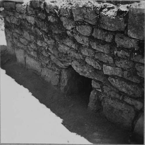 Entrance into stone lined side cist under south bench in east room
