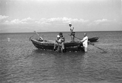 One man carrying another off boat