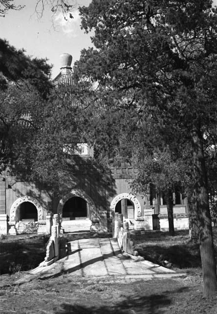 Small stone bridge leading to gateway with three arches