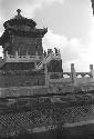 Ornate tiered structure with three men on top platform