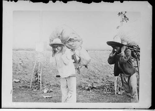 Two men carrying packs