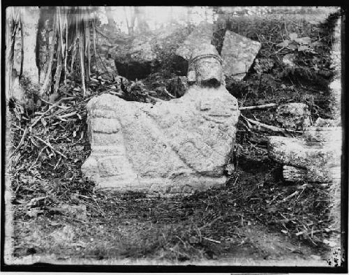 Recumbent figure in Situ, facing stairway leading from the base