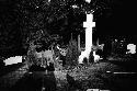 Woman and man standing by gravestone