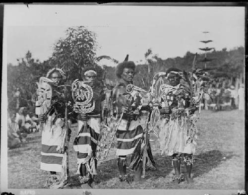 Men dancing and totems