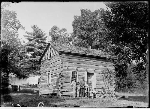 Harry Kettle and Family -- Showing Log House