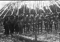 Men in front of half constructed house