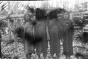 Women in front of partially constructed hut