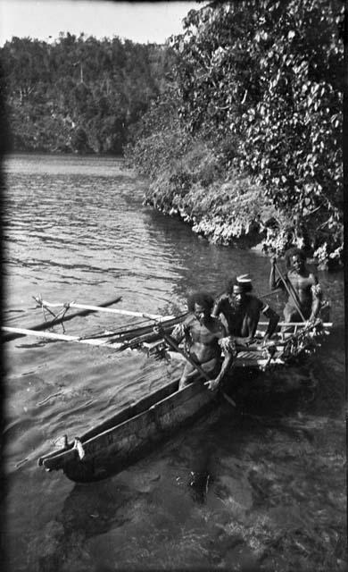 Three men setting out on canoe