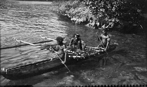 Three men setting out on canoe