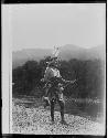 Man in native dress next to river