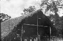 Group of people in a hut in the rain forest