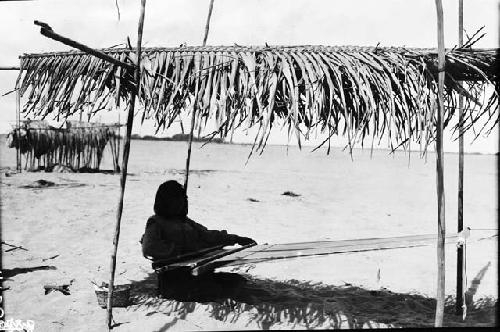 Man or woman weaving on a loom