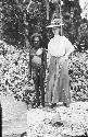 Indigenous man standing next to white woman