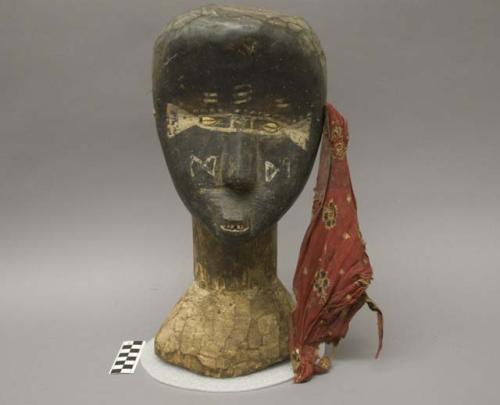 Wooden head fetish of the Sande Society; red rag attached at left ear