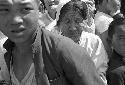 Woman and children in a crowd bunched together