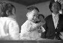 Portrait of baby boy swinging toy in his hand