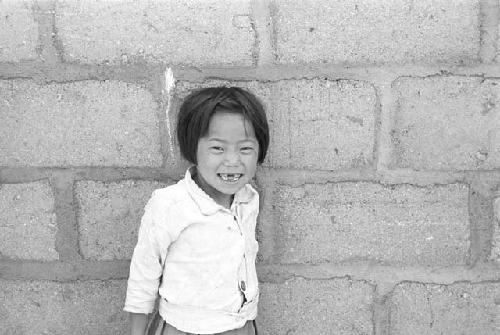 Portrait of girl outside leaning back against wall