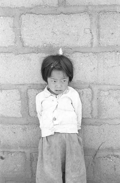 Portrait of girl outside leaning back against wall