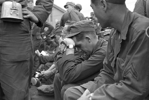 Portrait of soldiers sitting down in line