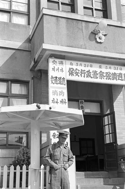 Soldier standing guard outside of building