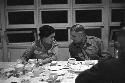 Man and woman sitting side by side conversating at dinner table