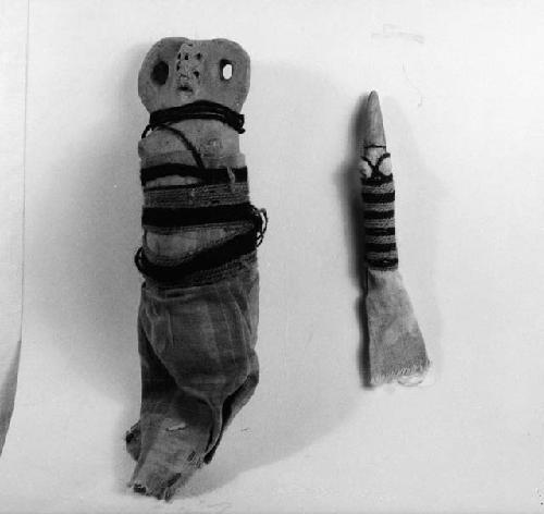 Two child's dolls of clay wrapped with cloth and thread - female (one pregnant)