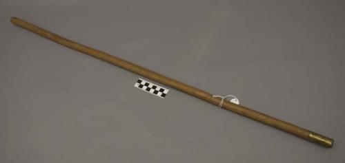 Wooden stick with brass tip, ceremonial?