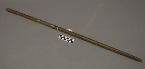 Wooden stick with 3 bands of metal around it, ceremonial?