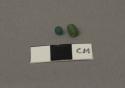 Two Indian glass beads, both drawn, one blue, one green
