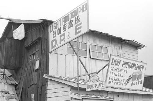 Sign of poster board of light photographer above house