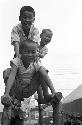 Portrait of children playing on wooden monkey bars