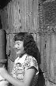 Portrait of woman standing by wall