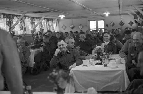 Soldiers sitting together in banquet room