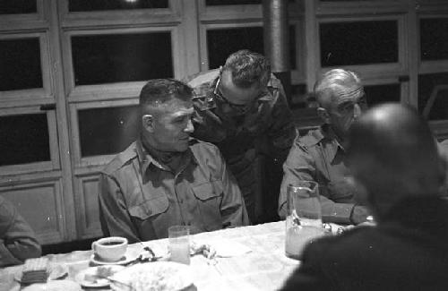 Soldiers siting at table having dinner