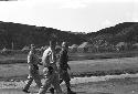 Soldiers walking outside together on open ground