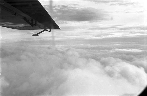 Plane wing and clouds