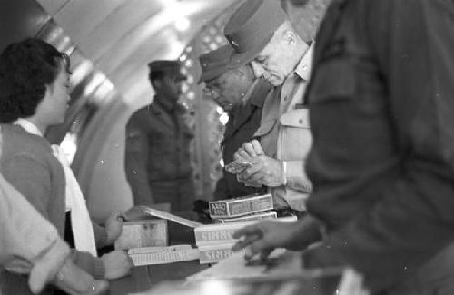 Soldiers checking in inside shop