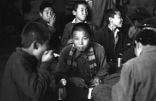 Portrait of children eating food from cans