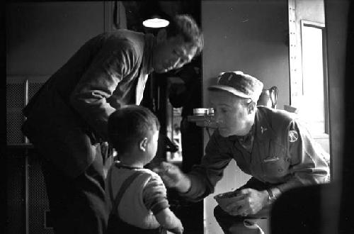 Boy being treated by soldier