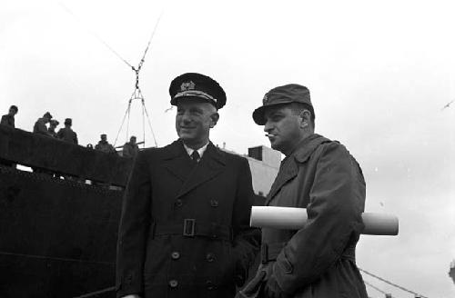 Portrait of two officers outside next to boat