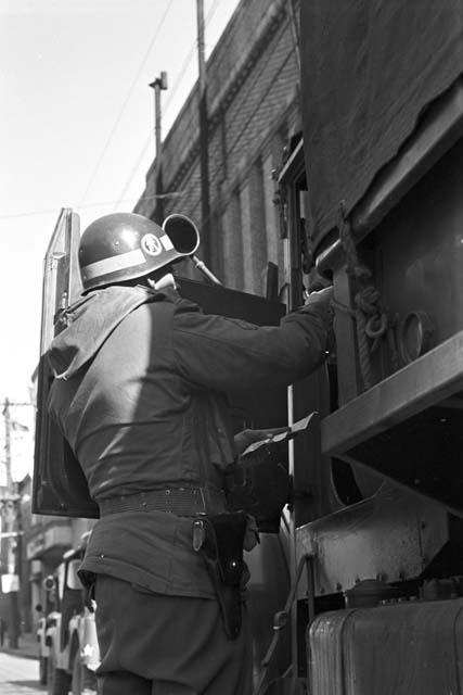 Soldier inspecting truck driver before clearence 2