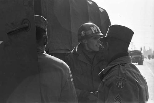 Portrait of soldiers standing by truck on standby