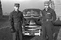 Portrait of soldiers standing outside in front of car