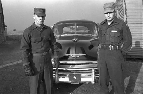 Portrait of soldiers standing outside in front of car