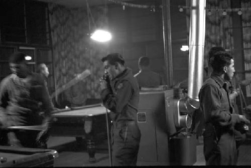 Soldiers in recreational room playing pool