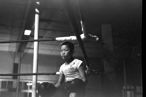 Boxer sitting in corner during bout 3