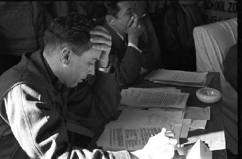 Portrait of soldier during meeting reading papers