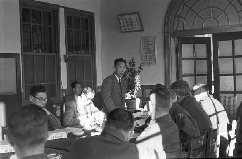 Portrait of man addressing participants in meeting