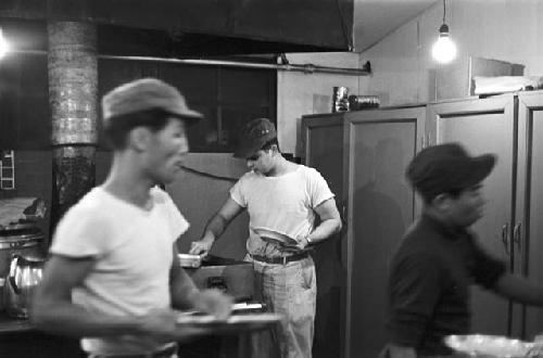 Bus boys in kitchen prepping