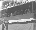 Officers saluting soldiers in crowd